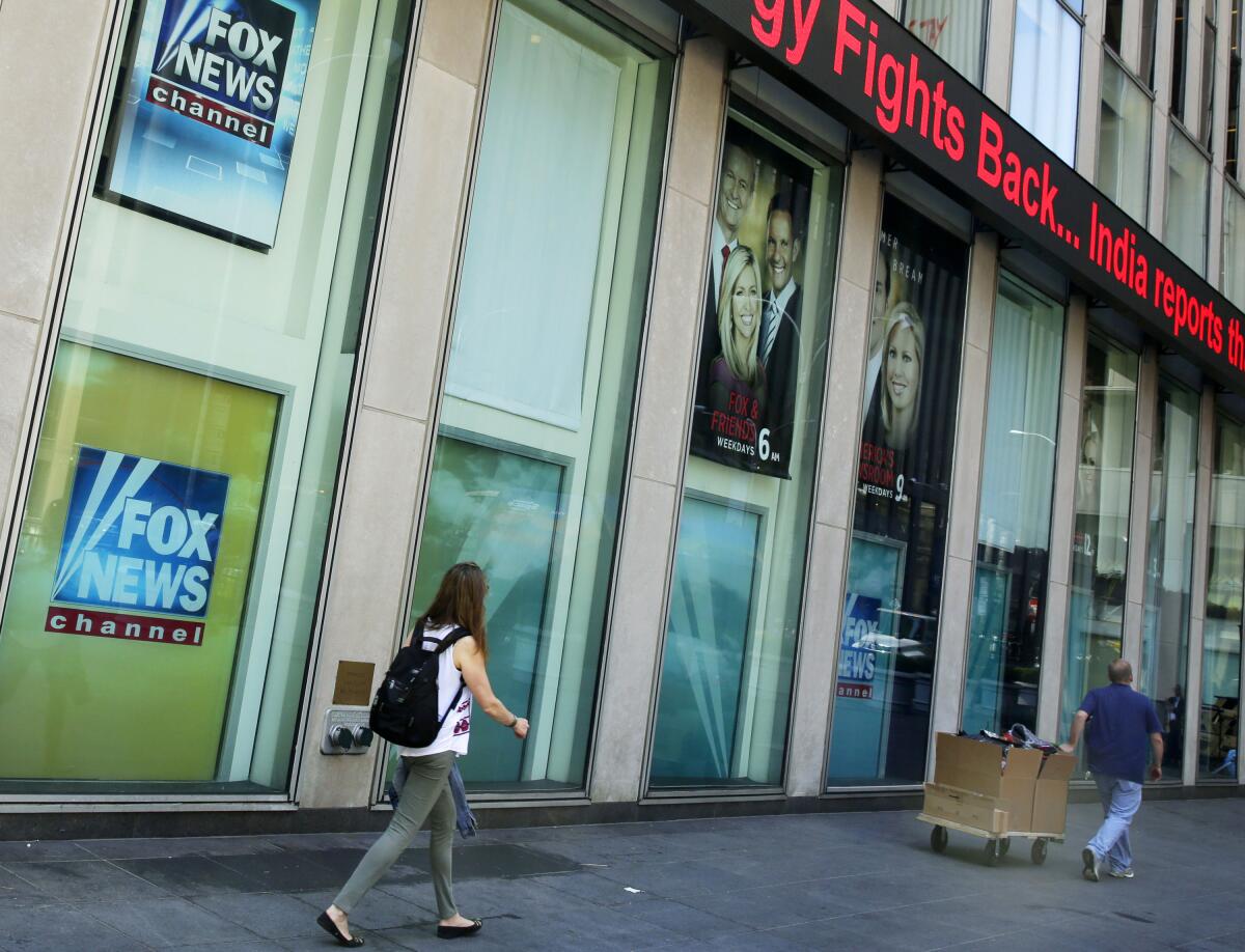 Pedestrians outside News Corp. headquarters and Fox News studios in New York