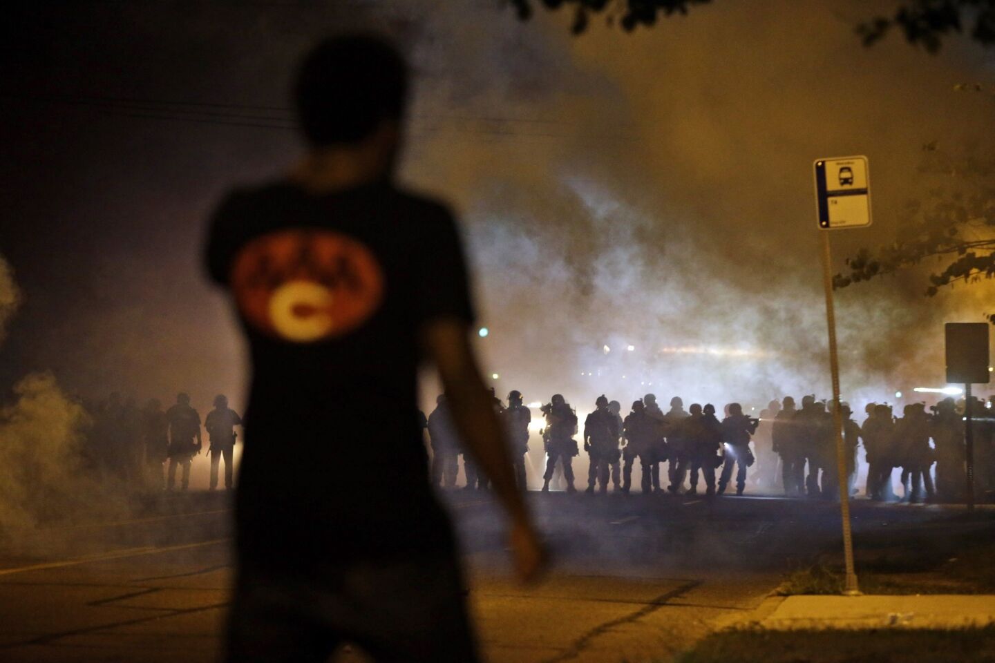 Smoke fills the nighttime air during a clash between police and protesters in Ferguson.