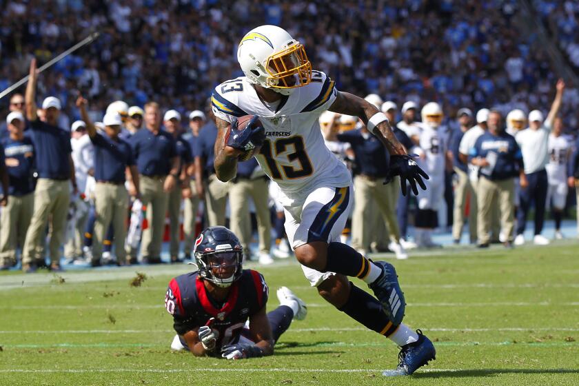 K.C. Alfred  U-T Chargers receiver Keenan Allen scores a touchdown after beating Texans defender Justin Reid on Sunday.