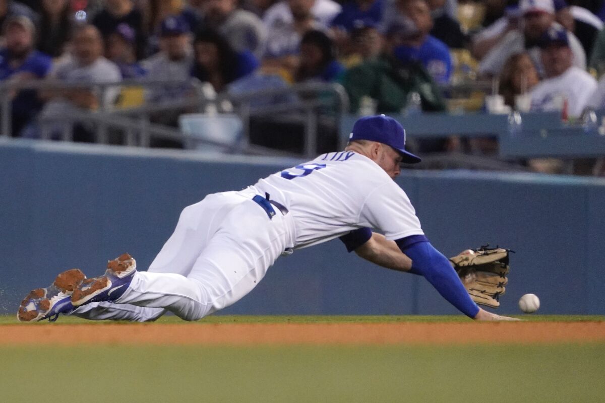 Dodgers second baseman Gavin Lux dives for a ball hit by Cleveland's Andres Gimenez.
