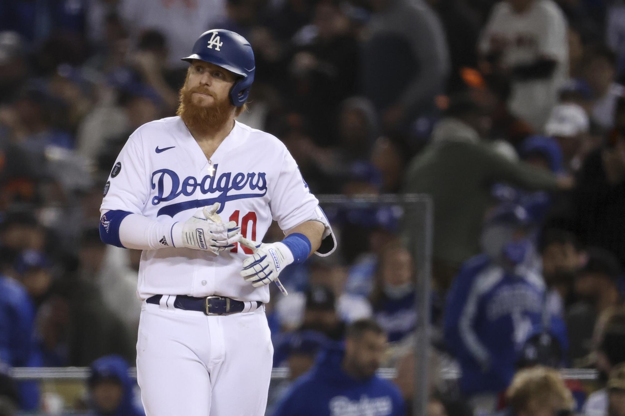 Dodgers batter Justin Turner walks off first after flying out to end the eighth inning.
