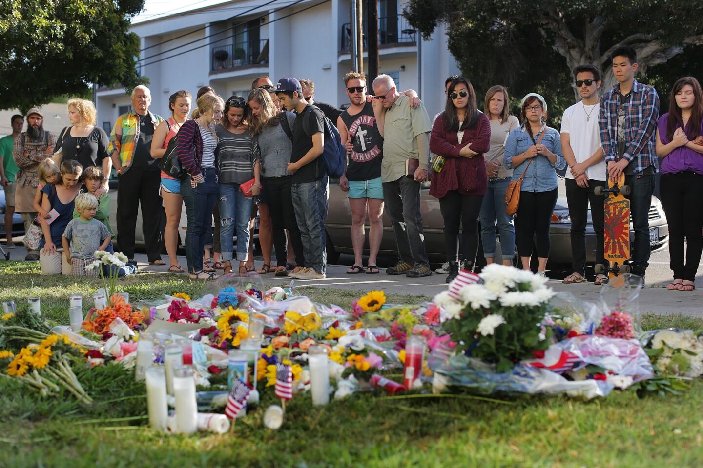 A large crowd gathers to pray and remember shooting victims Veronika Weiss and Katie Cooper outside the Alpha Phi sorority house in Isla Vista.