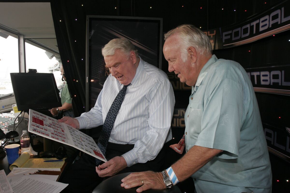 NFL legend John Madden, left, and former Rams and USC coach John Robinson.