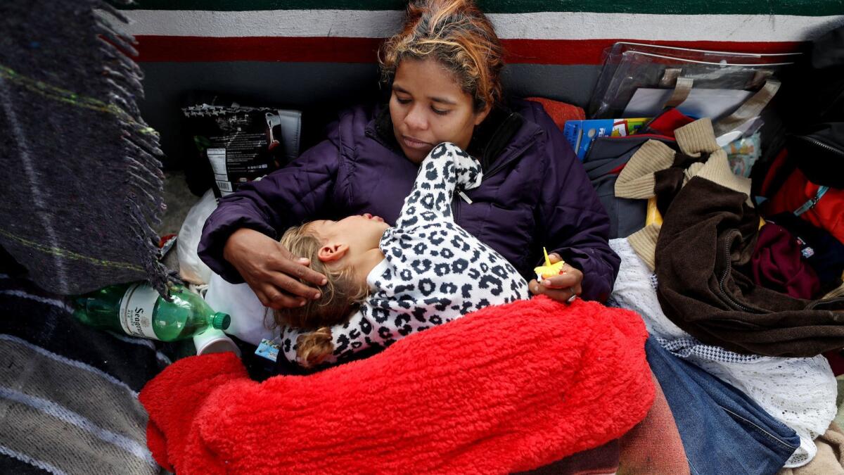 Wendi Garcia of Honduras and her son Oscar, 2, await an appointment for asylum at an encampment near the El Chaparral Port of Entry in Tijuana.