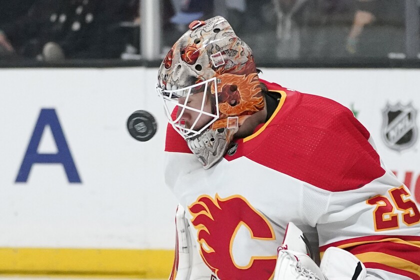 Calgary Flames goaltender Jacob Markstrom deflects a shot during the second period of an NHL hockey game against the Los Angeles Kings Thursday, Dec. 2, 2021, in Los Angeles. (AP Photo/Mark J. Terrill)