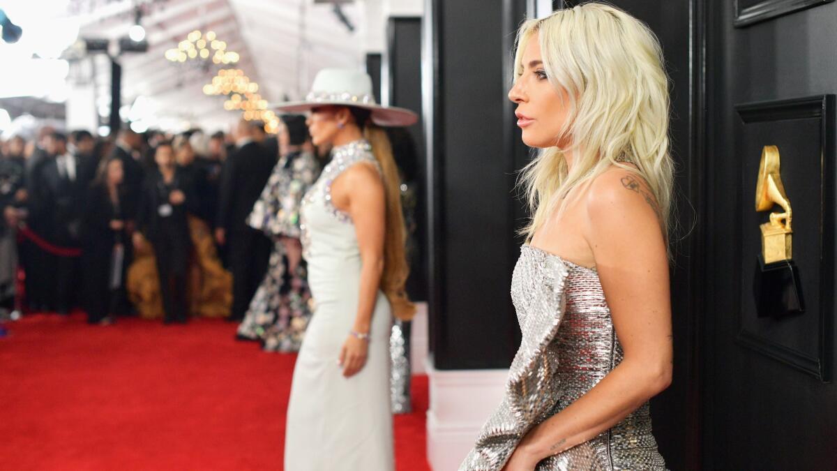 Lady Gaga with Jennifer Lopez in the background attends the 61st Grammy Awards at Staples Center in Los Angeles on Sunday. The two made our showstoppers list of best looks of the night.