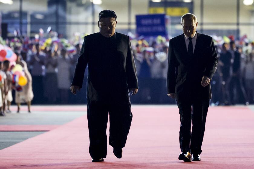 FILE -North Korea's leader Kim Jong Un, left, walks together with Russian President Vladimir Putin, right, during Putin's departure ceremony at an international airport outside Pyongyang, North Korea, June 19, 2024. (Gavriil Grigorov/Sputnik, Kremlin Photo via AP, File)