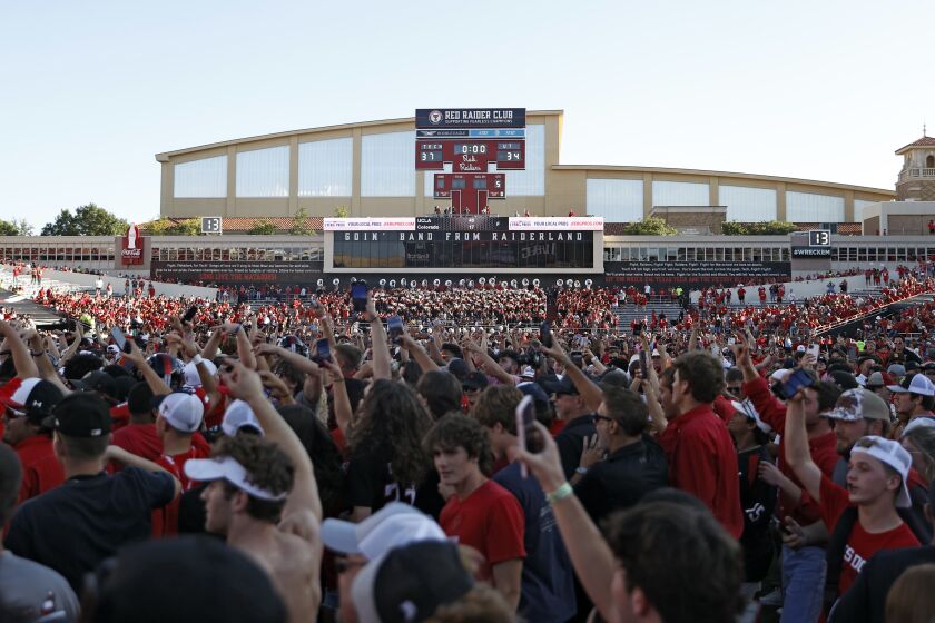 Texas Tech fans celebrate on the field after an NCAA college football game against Texas, Saturday, Sept. 24, 2022, in Lubbock, Texas. (AP Photo/Brad Tollefson)