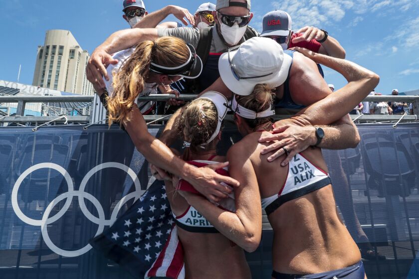 Tokyo, Japan, Friday, August 6, 2021 - Tokyo 2020 Alix Klineman (2) and April Ross (1) celebrate with friends after winning the Gold Medal at the Tokyo Olympics Beach Volleyball Women's Gold Medal Match at Shiokaze Park. (Robert Gauthier/Los Angeles Times)