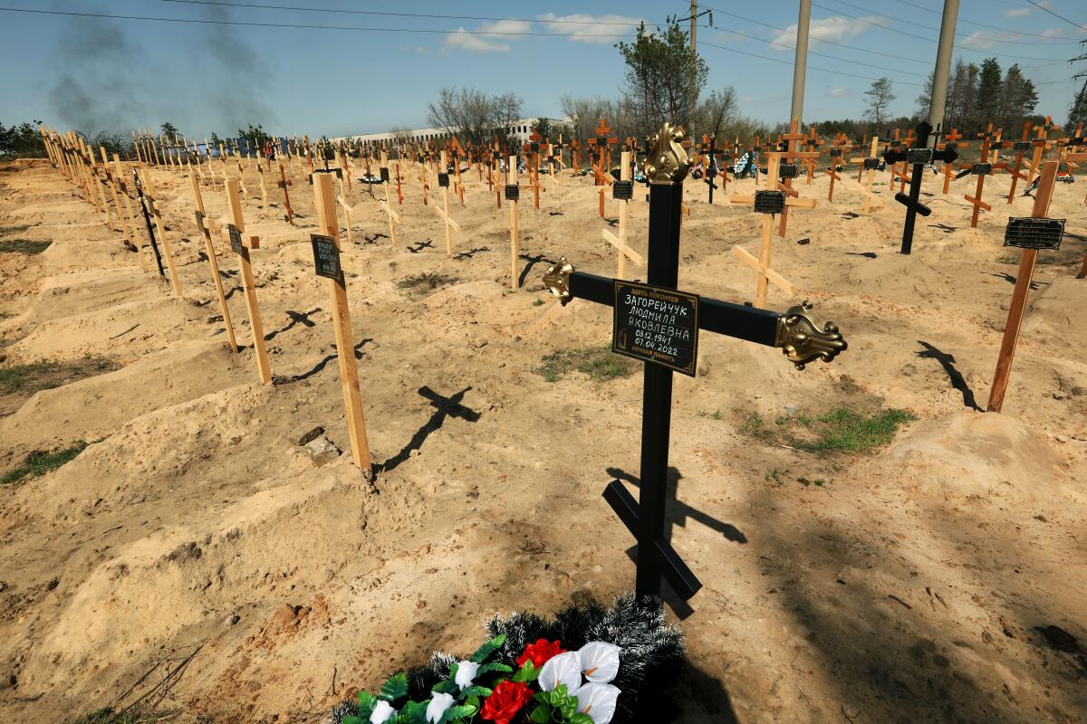 Rows and rows of crosses mark fresh graves.