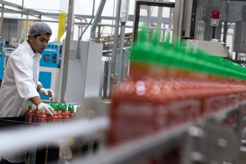 Jostein Reyes works in the packaging area at Huy Fong Foods Inc. in Irwindale. Huy Fong Foods Inc. is known for its Sriracha hot sauce.