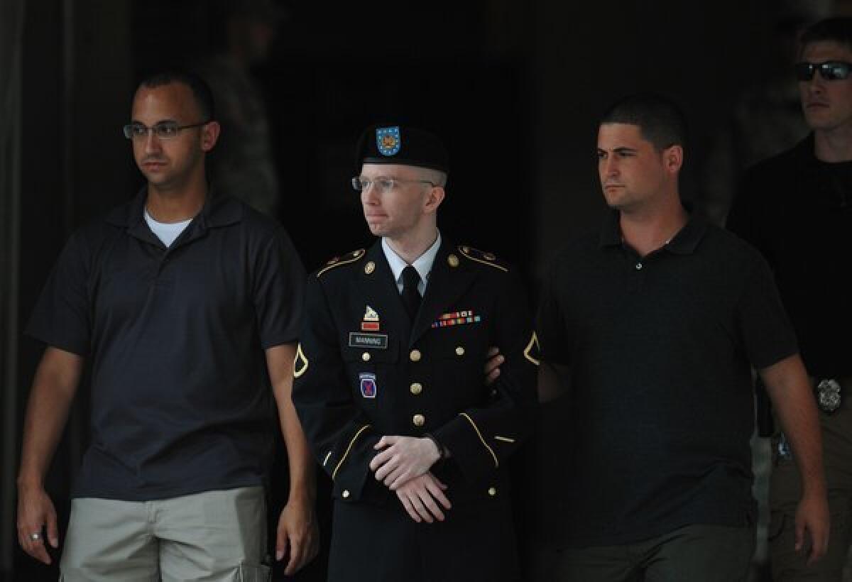 Army Pfc. Bradley Manning with his security escort outside court at Fort Meade, Md.