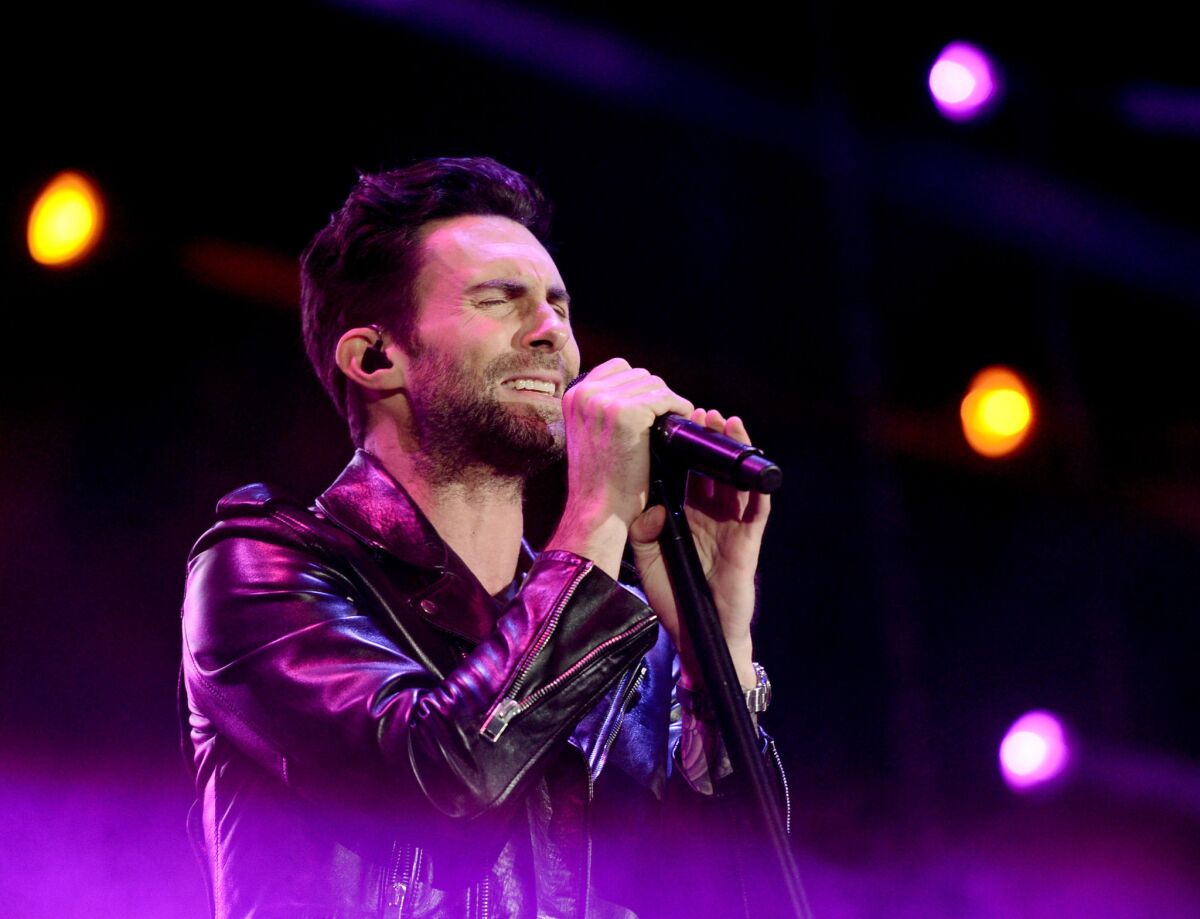 Adam Levine, shown performing with Maroon 5 at KIIS FM's Wango Tango earlier this month, offended many viewers by muttering "I hate this country" Tuesday night on NBC-TV's "The Voice."