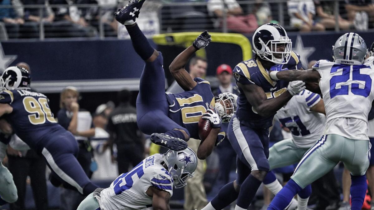 Rams kick returner Pharoh Cooper is flipped by Cowboys' Rod Smith.