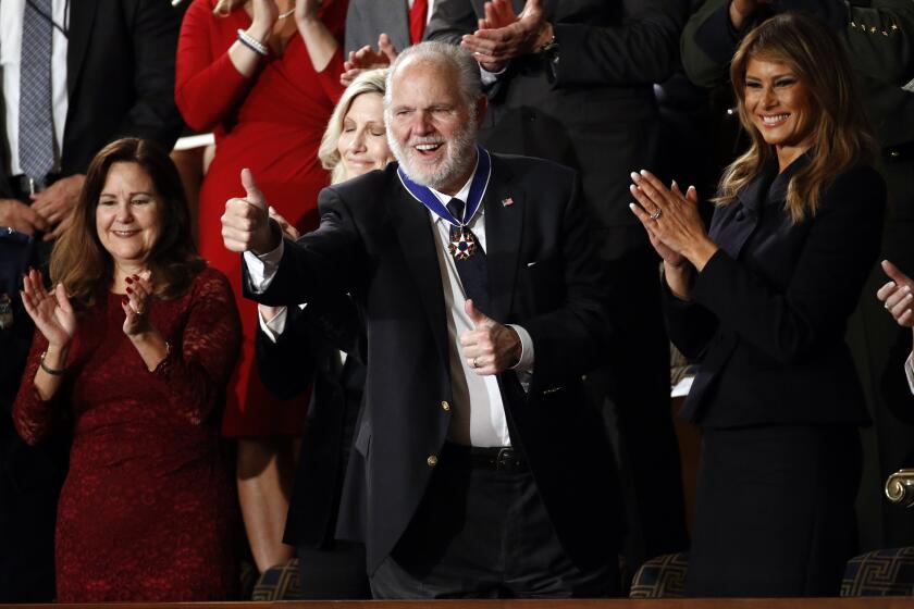 Rush Limbaugh reacts after first Lady Melania Trump presented him with the the Presidential Medal of Freedom as President Donald Trump delivers his State of the Union address to a joint session of Congress on Capitol Hill in Washington, Tuesday, Feb. 4, 2020. Second lady Karen Pence is at left and Kathryn Limbaugh is partially hidden. (AP Photo/Patrick Semansky)