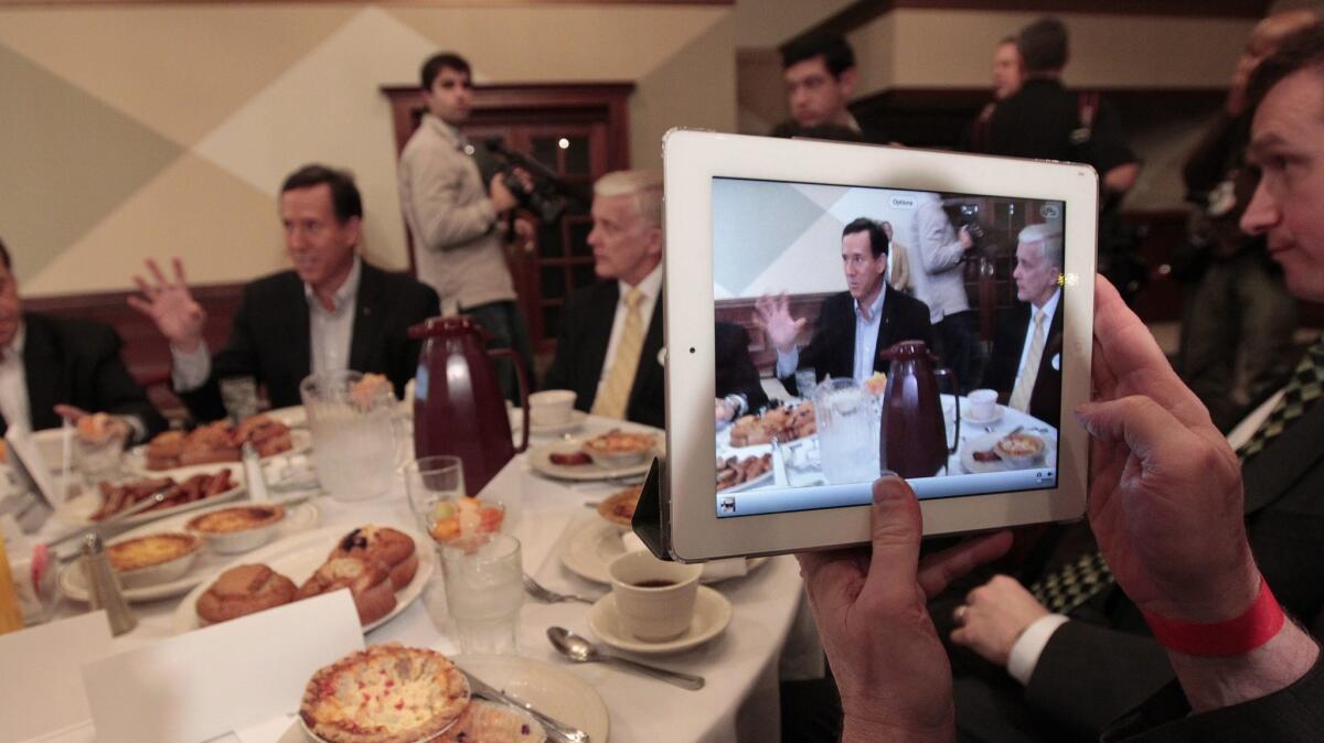 Republican presidential candidate Rick Santorum is photographed on an iPad at the Livonia/Farmington Chamber of Commerce Breakfast at St. Mary's Cultural & Banquet Center in Livonia, Mich.
