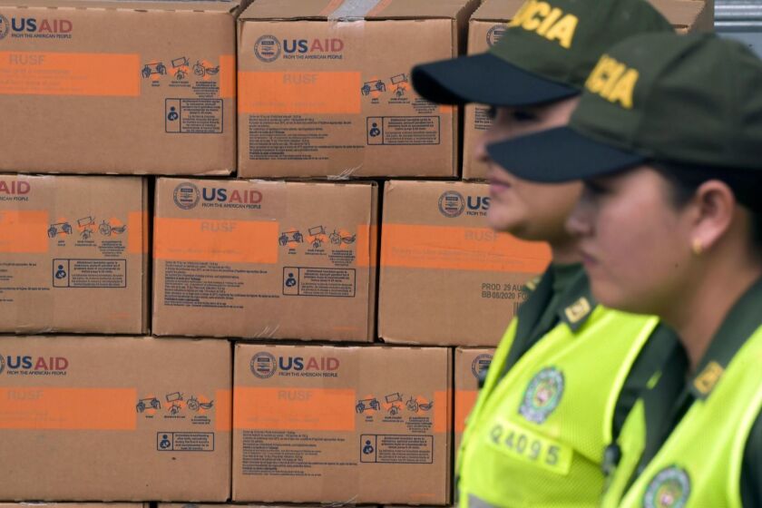 Colombian policewomen walk past boxes with US humanitarian aid goods in Cucuta, Colombia, on the border with Tachira, Venezuela, on February 8, 2019. - Venezuelan military officers blocked a bridge on the border with Colombia ahead of an anticipated humanitarian aid shipment, as opposition leader Juan Guaido stepped up his challenge to President Nicolas Maduro's authority. (Photo by Raul ARBOLEDA / AFP)RAUL ARBOLEDA/AFP/Getty Images ** OUTS - ELSENT, FPG, CM - OUTS * NM, PH, VA if sourced by CT, LA or MoD **