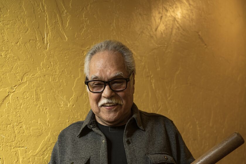 Playwright Luis Valdez holds a police baton, used in the 1943 Zoot Suit riots