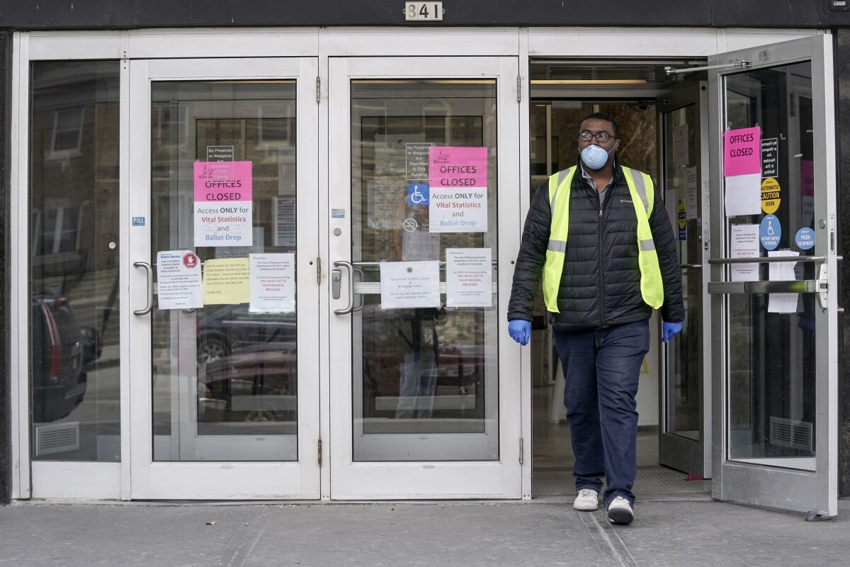 A worker leaves the the Frank P. Zeidler Municipal Building on Monday in Milwaukee.