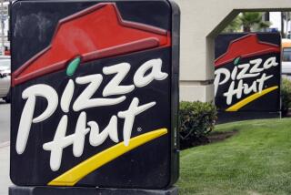 FILE - In this Oct. 5, 2010, file photo, a the front of a Pizza Hut restaurant is seen in Los Angeles. The AP reported on Oct. 5, 2017, that an online coupon offering three free pizzas to celebrate the anniversary of the pizza chain is a hoax. (AP Photo/Reed Saxon, File)