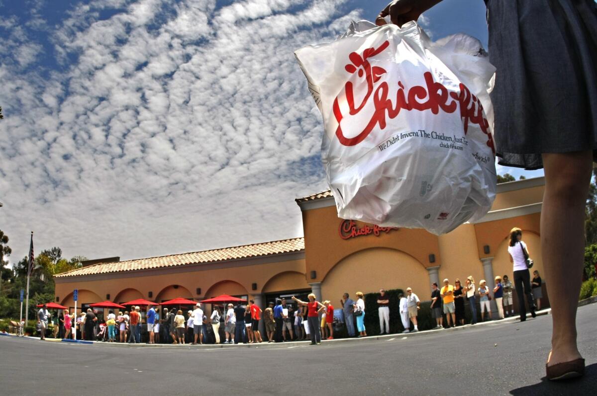 Atlanta-based Chick-fil-A said it would stop serving chicken raised on antibiotics. Above, a 2012 file photo shows customers lining up at a Laguna Niguel restaurant.