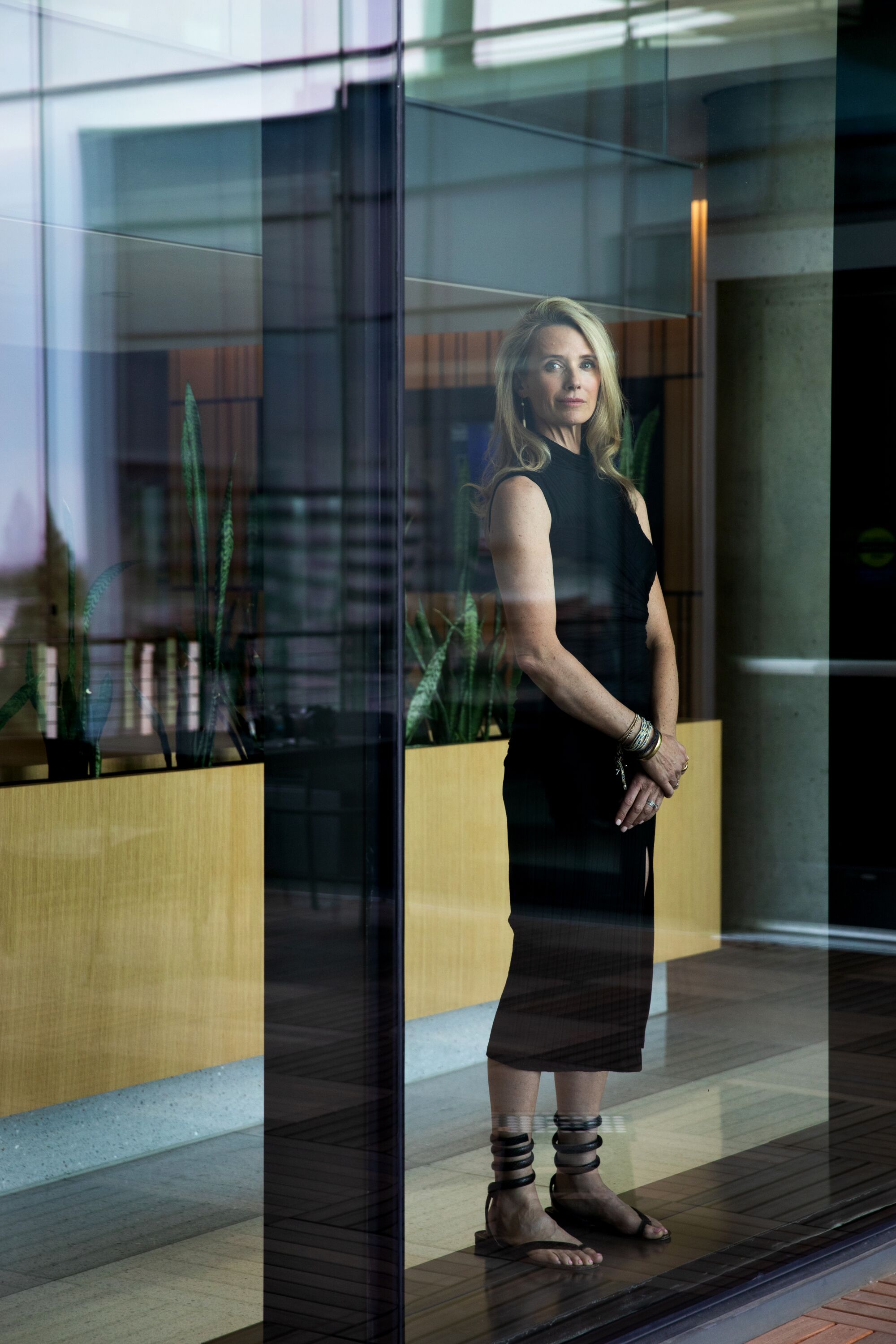 Jennifer Siebel Newsom standing and looking out a full-length window