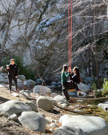 Hikers enjoy a swing places near Swtizer Falls, in the Angeles Nationa