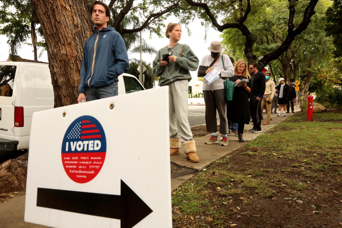 Voters wait in line to cast their votes in the midterm elections at Plummer Park in West Hollywood.