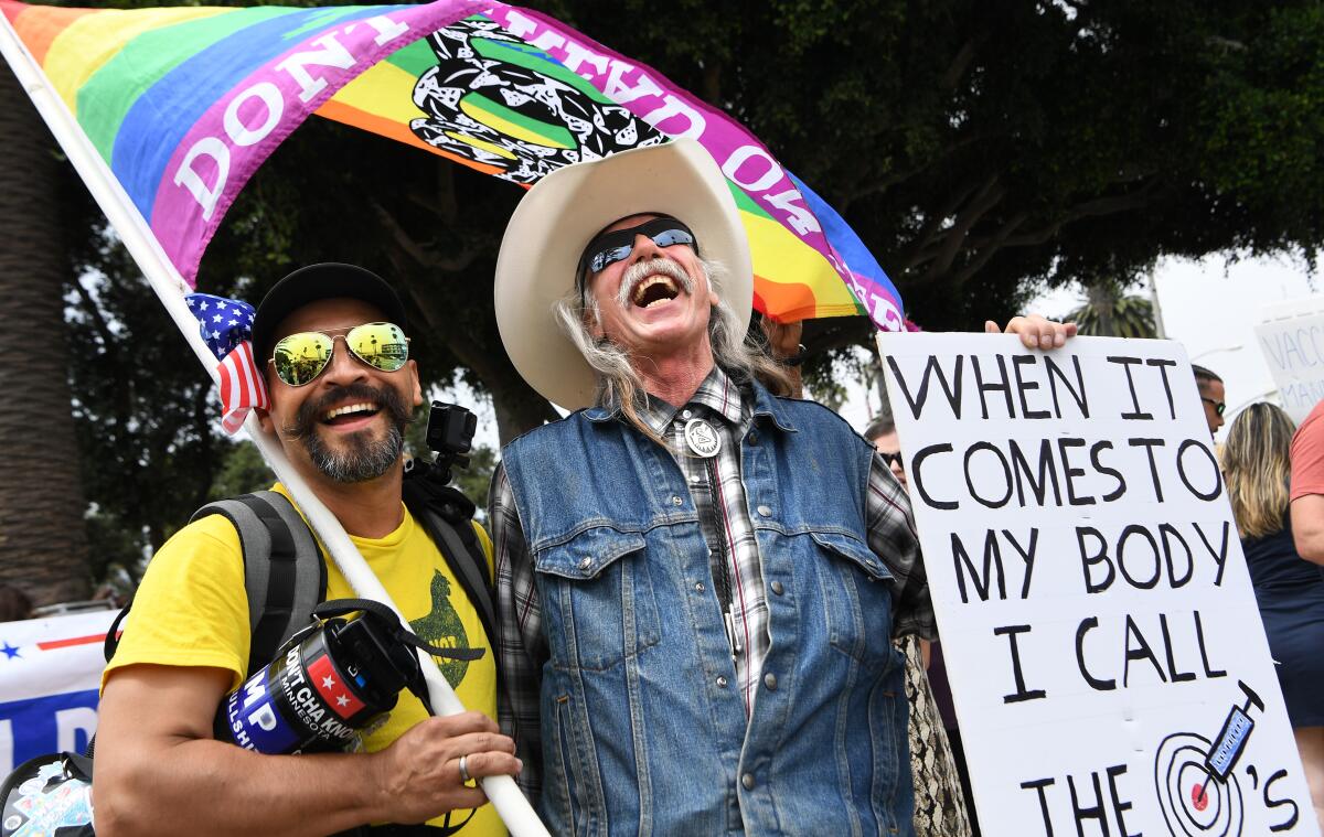 Two men share a laugh at a rally near the Santa Monica Pier for a "worldwide rally for freedom" Sunday. 