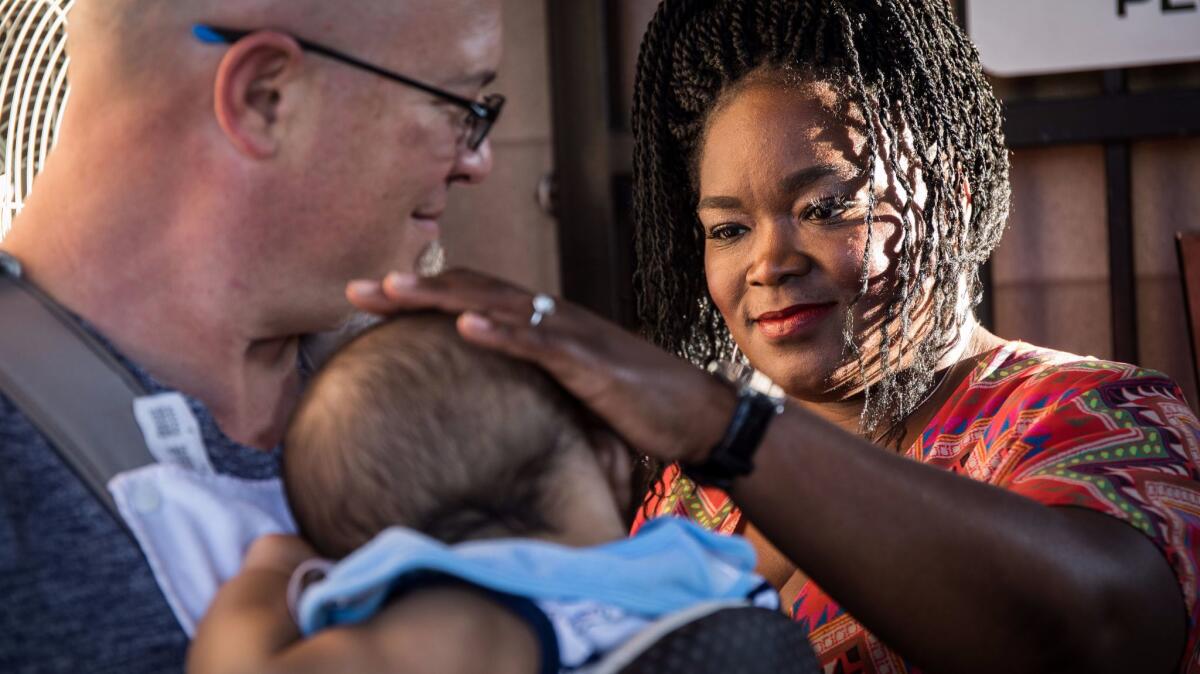 Shemekia Copeland with her son held by her partner Brian Schultz seconds before taking stage at Blues on the Fox festival.