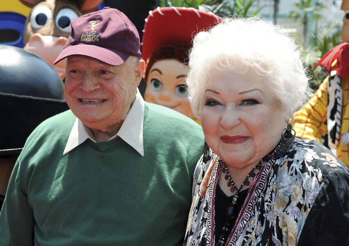 FILE - Estelle Harris, at right, and Don Rickles arrive at the world premiere of "Toy Story 3," Sunday, June 13, 2010, at The El Capitan Theater in Los Angeles. Harris, who hollered her way into TV history as George Costanza’s short-fused mother on TV’s “Seinfeld” and voiced Mrs. Potato Head in the “Toy Story” franchise, has died. She was 93. Harris’ agent Michael Eisenstadt confirmed the actor’s death in Palm Desert, Calif., late Saturday, April 2, 2022. (AP Photo/Katy Winn, File)