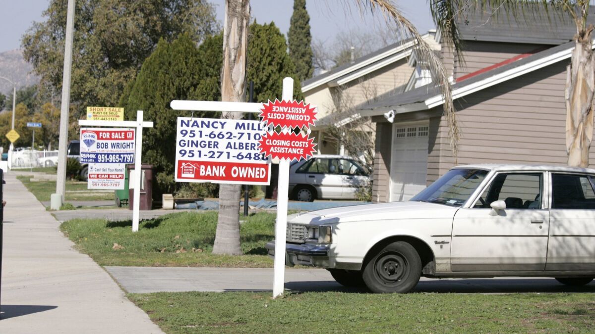 Signs advertise homes for sale in a Moreno Valley neighborhood in 2009.