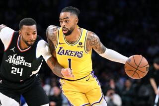 Los Angeles, California November 1, 2023- Lakers D'Angelo Russell drives past Clippers Norman Powell.