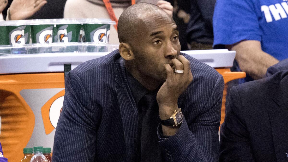 Kobe Bryant watches from the bench as the Lakers play the Thunder on Dec. 19.