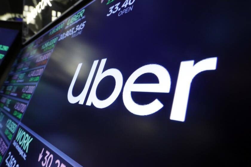 FILE - The logo for Uber appears above a trading post on the floor of the New York Stock Exchange, Aug. 16, 2019. The ride-hailing and delivery company said Wednesday, Oct. 4, 2023, that its drivers will collect up to five prepaid and sealed packages and drop them off at a local post office or at UPS or FedEx stores. Uber will charge a flat fee of $5 for the service or $3 for its Uber One members. (AP Photo/Richard Drew, File)