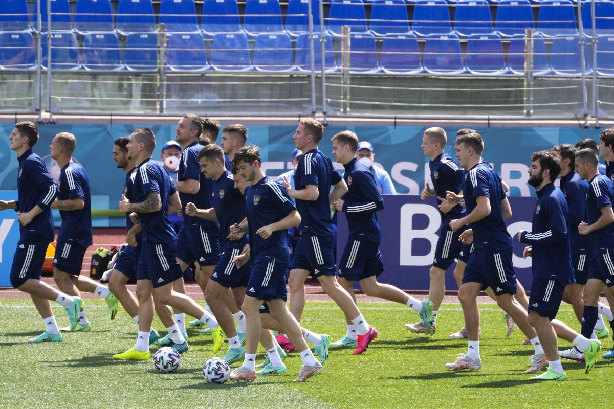 Russia players warm up during a training session of the national team at Petrovsky stadium in St. Petersburg, Russia, Friday, June 11, 2021, on the eve of the Euro 2020 soccer championship group B match between Russia and Belgium. The Euro 2020 gets underway on Friday June 11 and is being played in 11 host cities across 11 countries. The event was delayed by one year after being postponed in 2020 due to the COVID-19 pandemic. (AP Photo/Dmitri Lovetsky)