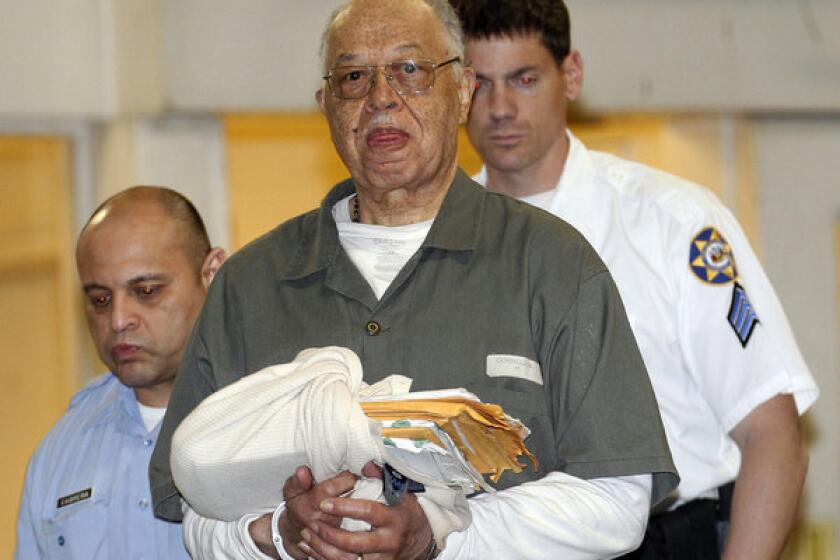 Dr. Kermit Gosnell is escorted to a police van upon leaving the Criminal Justice Center in Philadelphia after being convicted.
