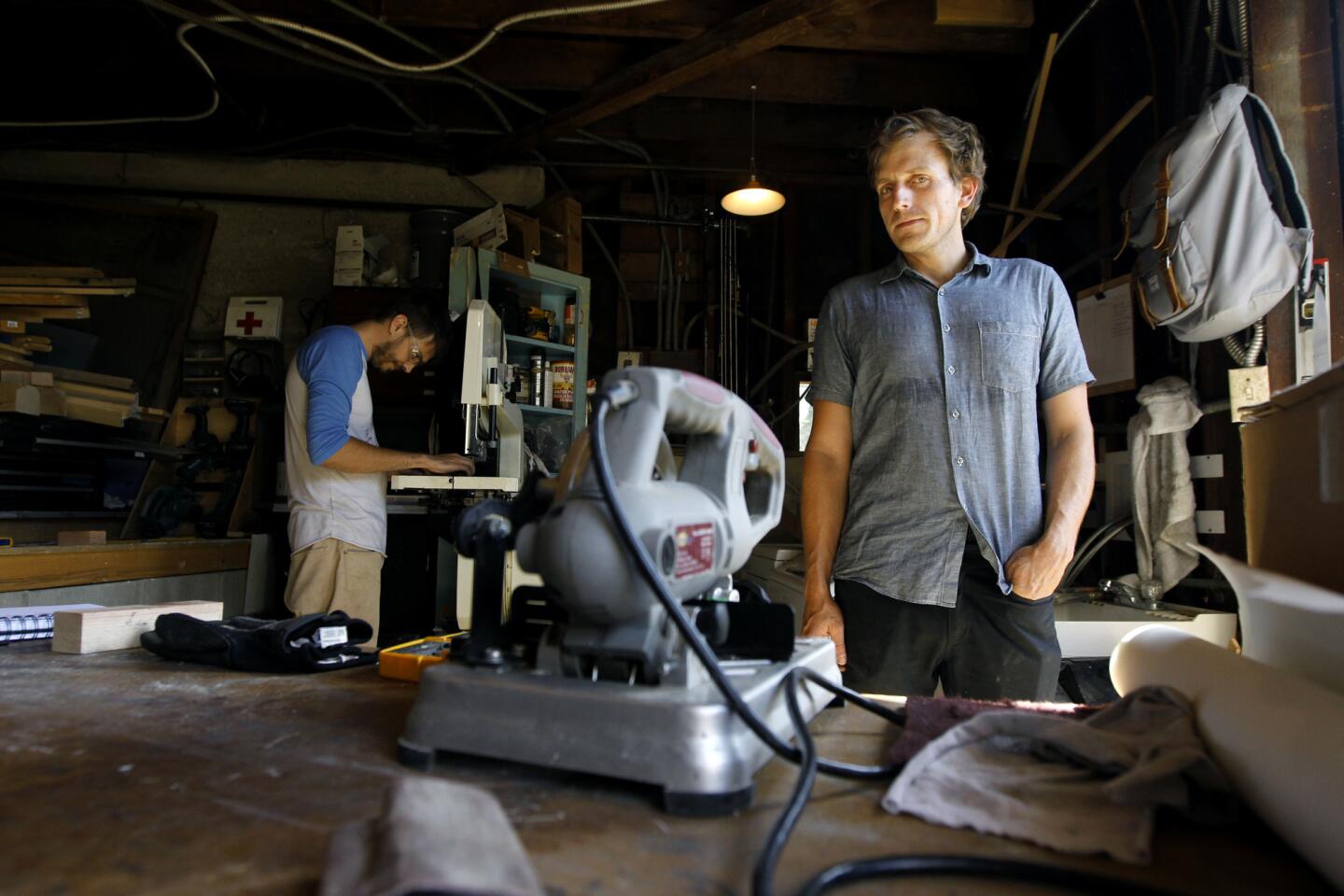 Furniture and lighting designer Brendan Ravenhill, right, runs his small industrial design studio out of his Echo Park home. At left, designer Dash Krehel.