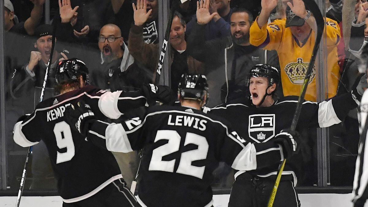 Kings defenseman Paul LaDue, right, celebrates his goal with left wing Adrian Kempe, left, and center Trevor Lewis during the third period against the Edmonton Oilers on Wednesday.
