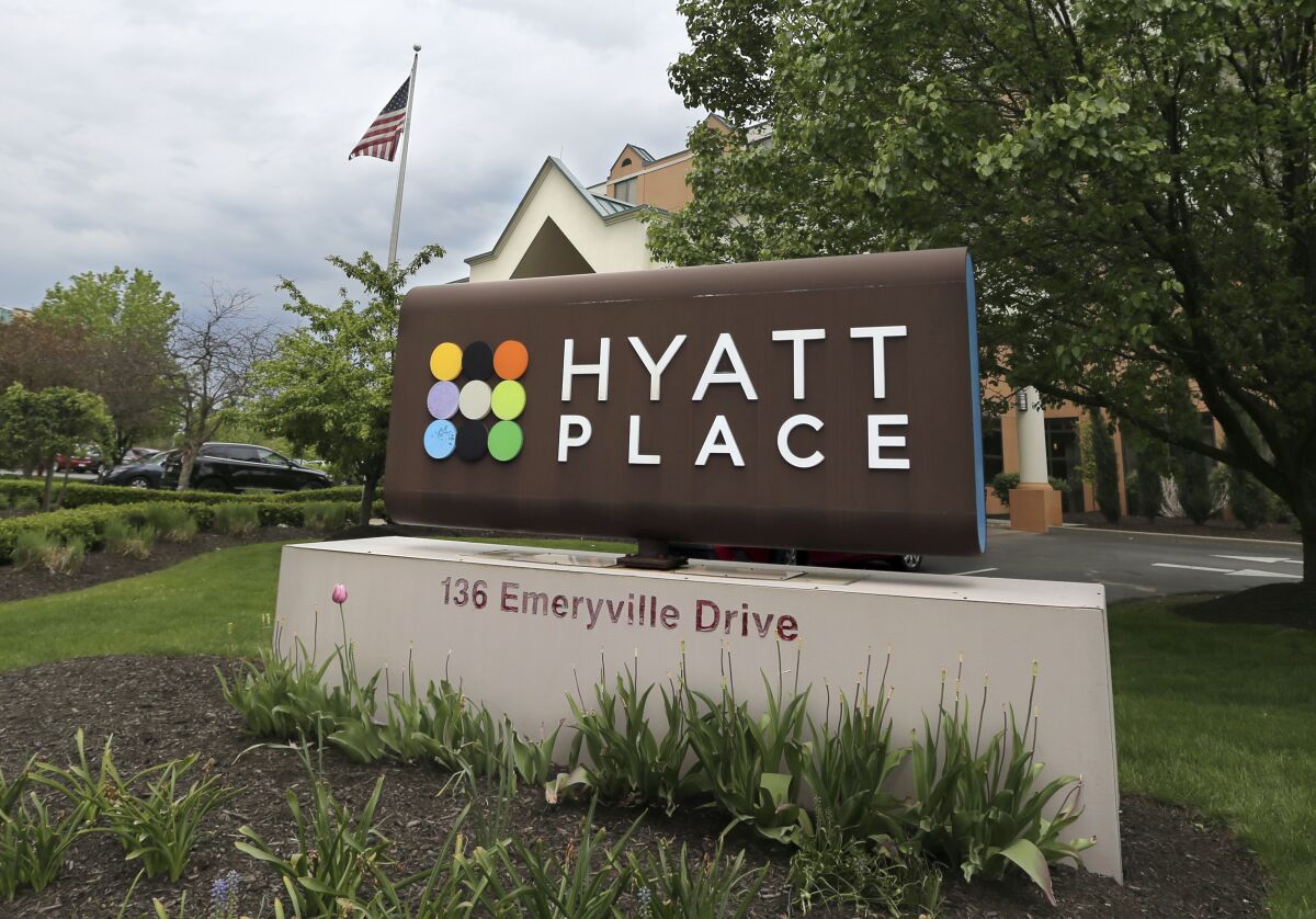 FILE - In this May 4, 2017 file photo, signs for the Hyatt Place hotel mark its location in Carnberry, Pa. U.S. hotel demand likely won’t see a full recovery until 2023, according to a new forecast from travel data company STR and consultant Tourism Economics. The two firms say they expect average hotel occupancy of 40% this year, slowly climbing to 52% in 2021. (AP Photo/Keith Srakocic)