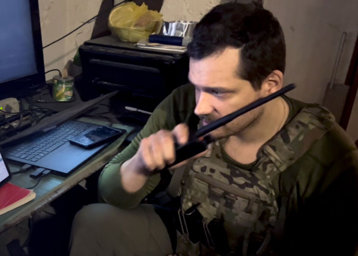 A Ukrainian battalion’s mortar commander, who goes by the name Zeus, communicates coordinates and adjustments to his team.