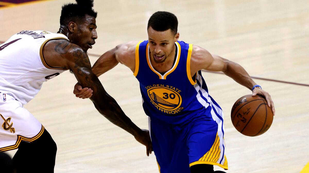 Warriors guard Stephen Curry tries to drive past Iman Shumpert during Game 3