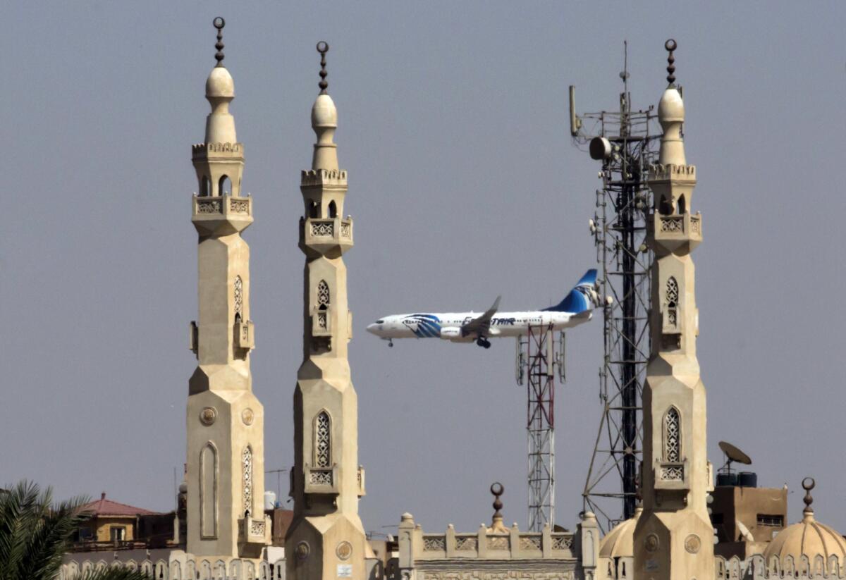 An EgyptAir plane flies past the minarets of a mosque as it approaches Cairo International Airport on May, 21, 2016.