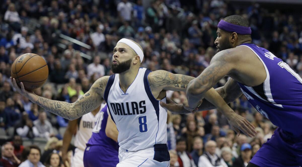 Dallas Mavericks guard Deron Williams drives past Sacramento Kings forward DeMarcus Cousins during the second overtime of a game Jan. 5.