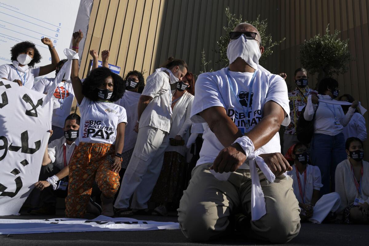Demonstrators participate in a silent protest for climate justice and human rights at the COP27 U.N. Climate Summit, Thursday, Nov. 10, 2022, in Sharm el-Sheikh, Egypt. (AP Photo/Peter Dejong)