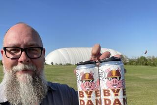 Chris Burns, owner of Old Ox Brewery of Ashburn, Va., holds Bye Dan beer.
