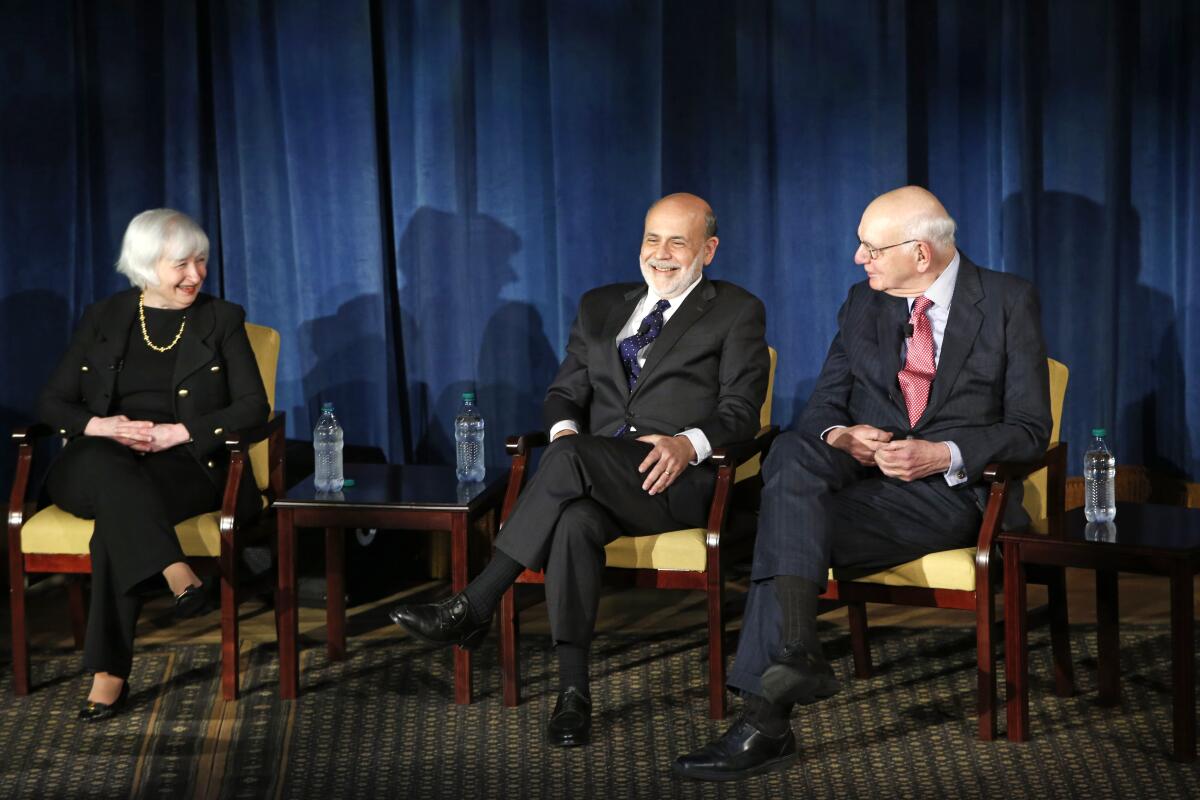 FILE - In this April 7, 2016, file photo Federal Reserve chair Janet Yellen, left, and former Federal Reserve chairs Ben Bernanke, center, and Paul Volcker, right, react as they listen to former Fed Chair Alan Greenspan appearing via video conference, during a panel discussion in New York. Volcker, the former Federal Reserve chairman died on Sunday, Dec. 8, 2019, according to his office, He was 92. (AP Photo/Kathy Willens, File)