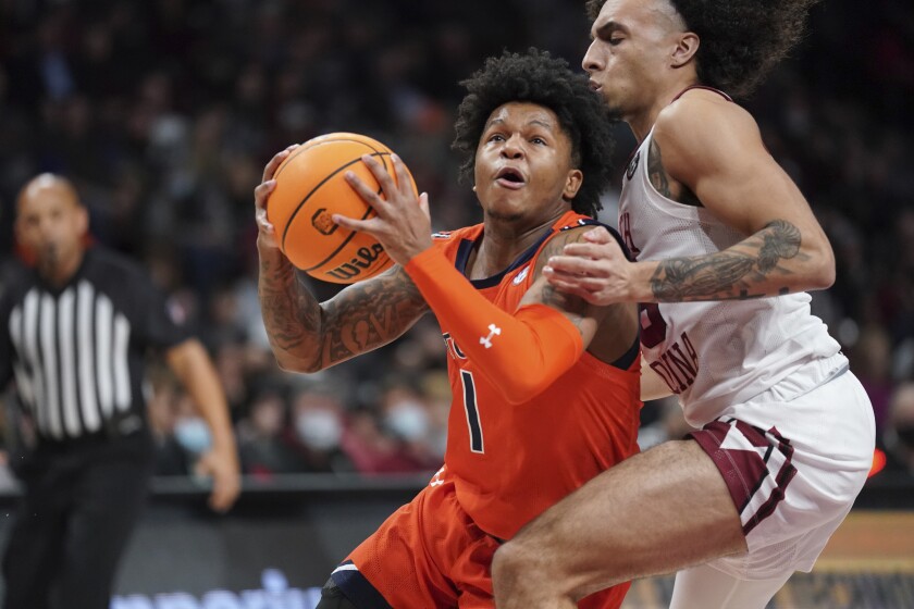Auburn guard Wendell Green Jr. (1) drives to the hoop against South Carolina guard Devin Carter, right, during the first half of an NCAA college basketball game Tuesday, Jan. 4, 2022, in Columbia, S.C. (AP Photo/Sean Rayford)