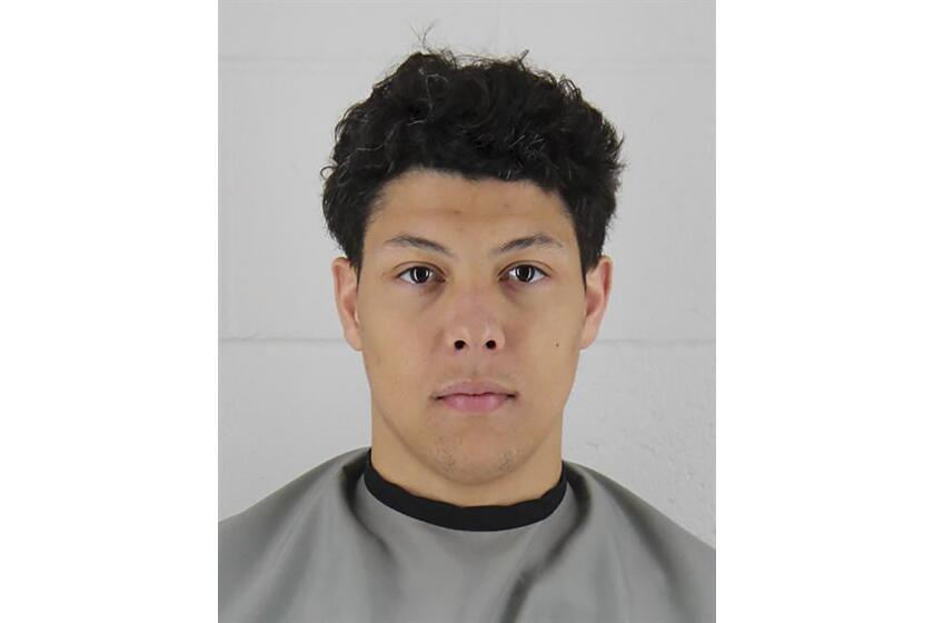 Jackson Mahomes is pictured in a mug shot with a stone faced expression. 