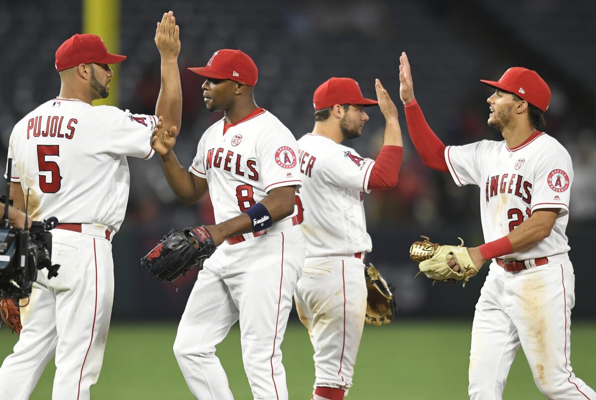 ANAHEIM, CA - JULY 15: Albert Pujols #5, Justin Upton #8, David Fletcher #6 and Michael Hermosillo celebrate a 9-6 win over the Houston Astros at Angel Stadium of Anaheim on July 15, 2019 in Anaheim, California. (Photo by John McCoy/Getty Images) ** OUTS - ELSENT, FPG, CM - OUTS * NM, PH, VA if sourced by CT, LA or MoD **